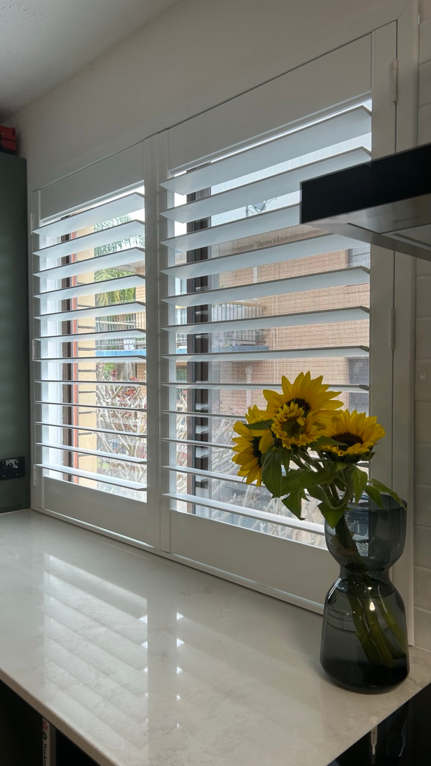 White 1500mm wide x 1200mm high 2-panel plantation shutters installed in a kitchen.